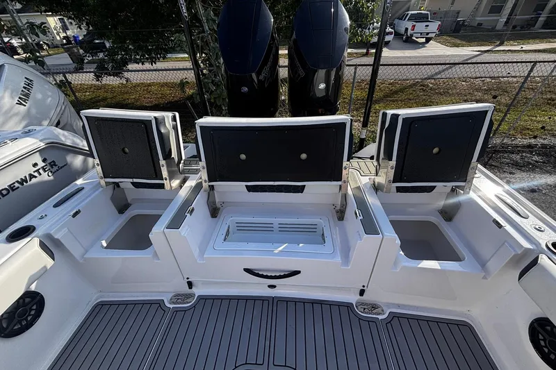 Slide: The Image of 2026 Tidewater 3100 Carolina Bay boat interior with storage compartments and seating. - 19