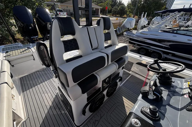 Slide: The Image of 2026 Tidewater 3100 Carolina Bay boat interior with dual seating and modern controls. - 23