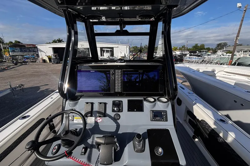 Slide: The Image of 2026 Tidewater 3100 Carolina Bay boat dashboard with steering wheel and control panel. - 25