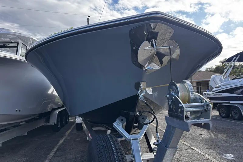 Slide: The Image of 2026 Tidewater 3100 Carolina Bay boat on trailer under a blue sky. - 3
