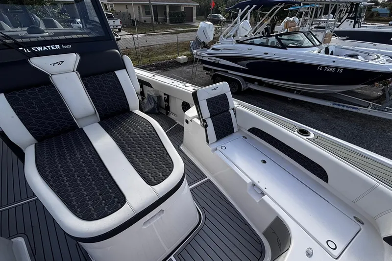 Slide: The Image of 2026 Tidewater 3100 Carolina Bay boat storage compartment, open lid, sleek design. - 40