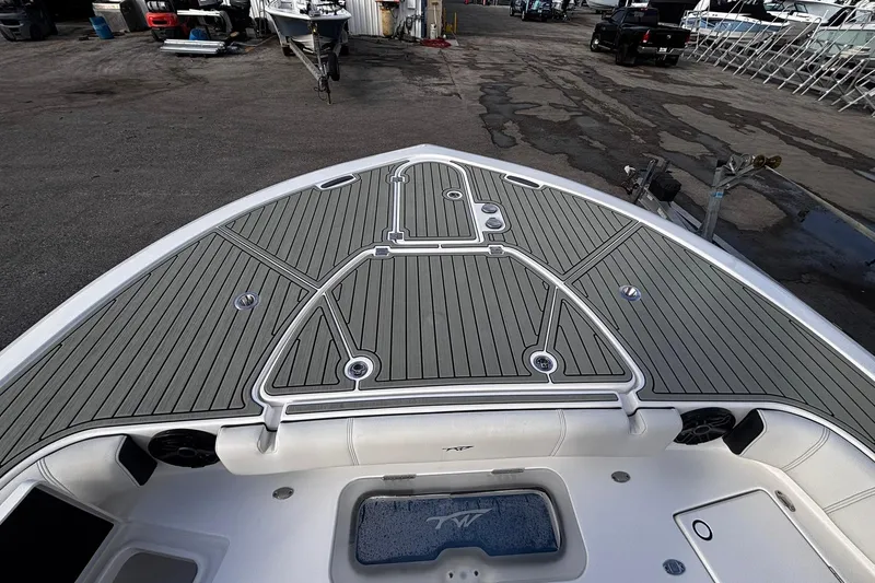 Slide: The Image of 2026 Tidewater 3100 Carolina Bay boat with open storage compartment at marina. - 43