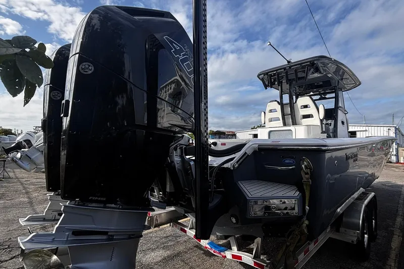 Slide: The Image of 2026 Tidewater 3100 Carolina Bay boat on trailer, showcasing powerful outboard motor and propeller. - 7