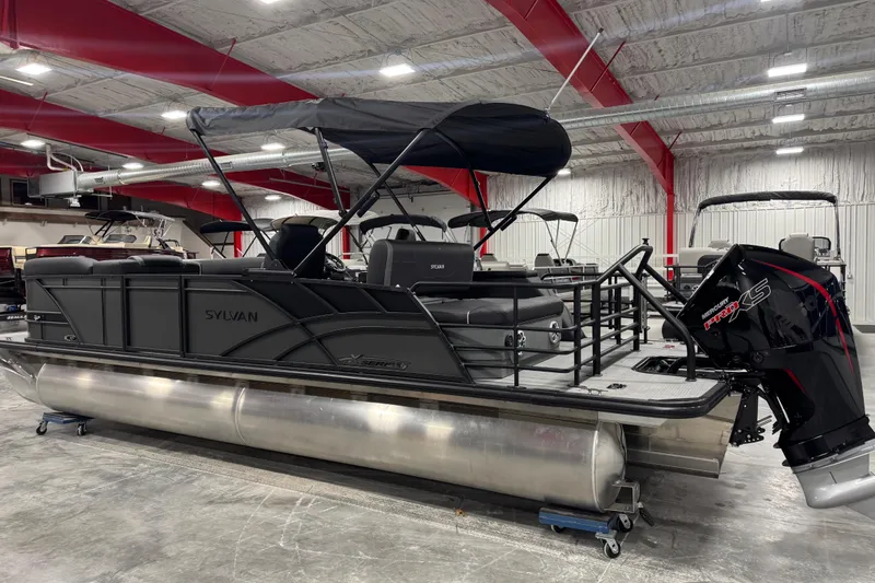 Slide: The Image of 2026 Sylvan X 5 pontoon boat with Mercury Pro XS engine in a showroom. - 3