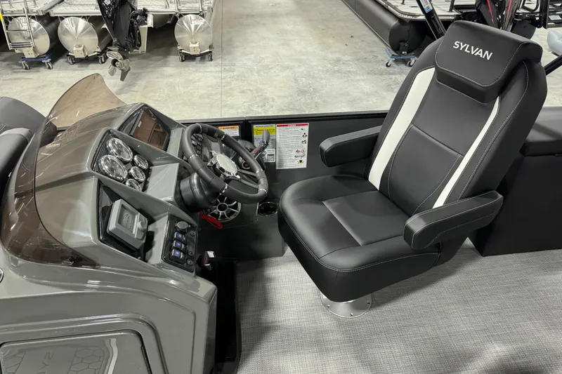 Slide: The Image of 2026 Sylvan X 5 boat interior with steering console and comfortable captain's chair. - 9