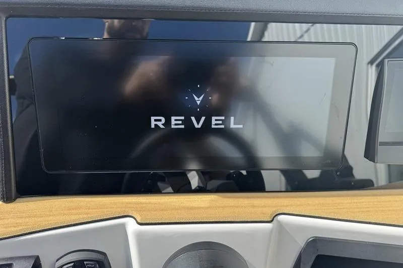 Slide: The Image of 2026 Revel RS25 boat dashboard with modern steering wheel and digital displays. - 11