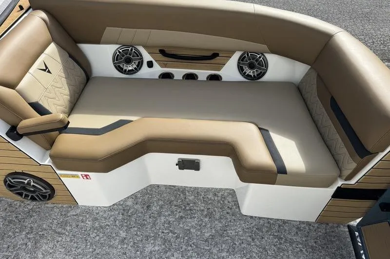 Slide: The Image of Luxurious seating in 2026 Revel RS25 boat with tan upholstery and built-in speakers. - 14