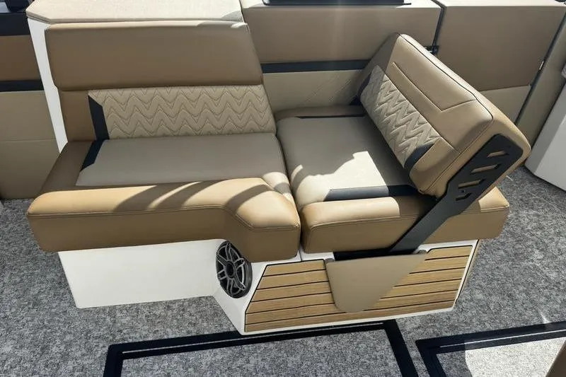 Slide: The Image of 2026 Revel RS25 boat interior with brown seating and wood accents. - 18