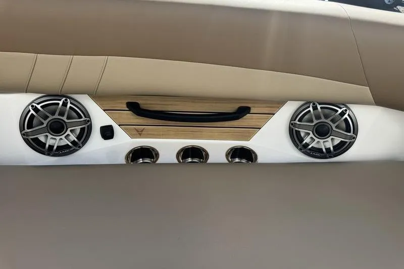 Slide: The Image of 2026 Revel RS25 boat cockpit with tan seating and modern steering console. - 20