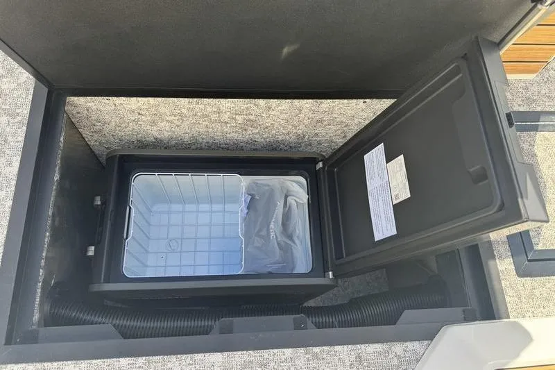 Slide: The Image of 2026 Revel RS25 boat interior with tan leather seating and cup holders. - 24