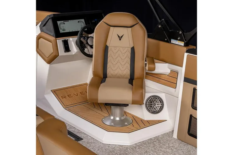 Slide: The Image of Manufacturer Provided Image: 2026 Revel RS25 boat interior with tan captain's chair and modern dashboard design. - 31