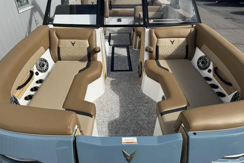 Slide: The Image of 2026 Revel RS25 boat with tan seating and modern design in a marina setting. - 4