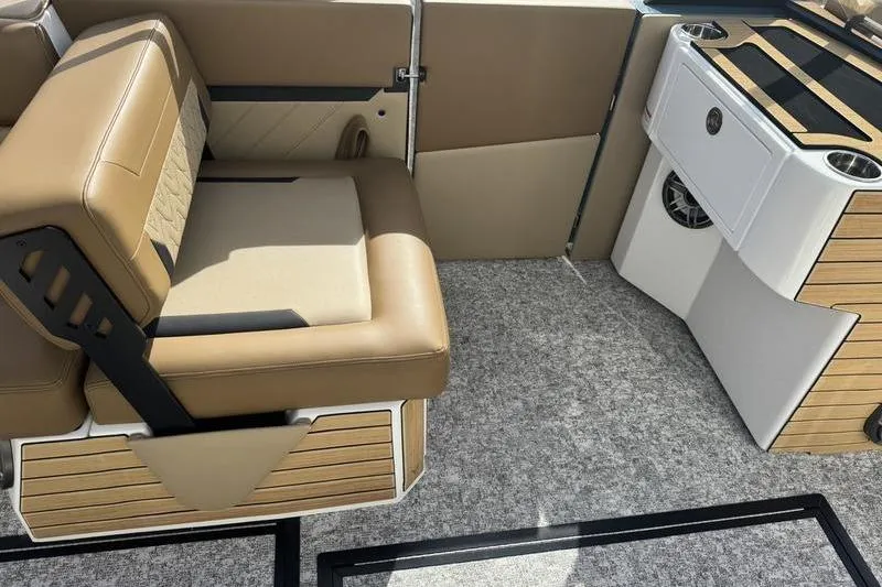 Slide: The Image of 2026 Revel RS25 boat interior with tan seating, speakers, and cup holders. - 5