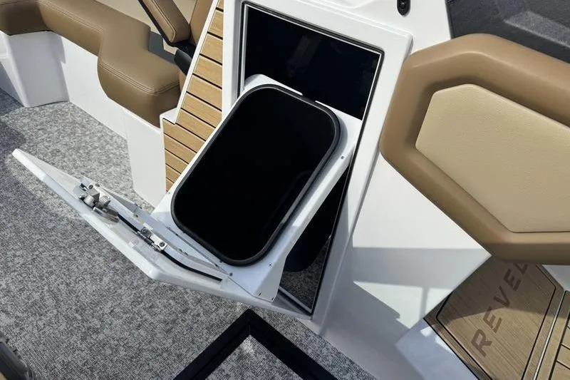 Slide: The Image of 2026 Revel RS25 boat interior with tan seating and modern console design. - 6