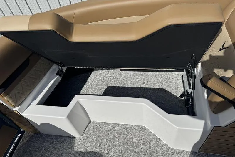 Slide: The Image of Revel RS25 2026 boat interior with open storage compartment and cushioned seating. - 7
