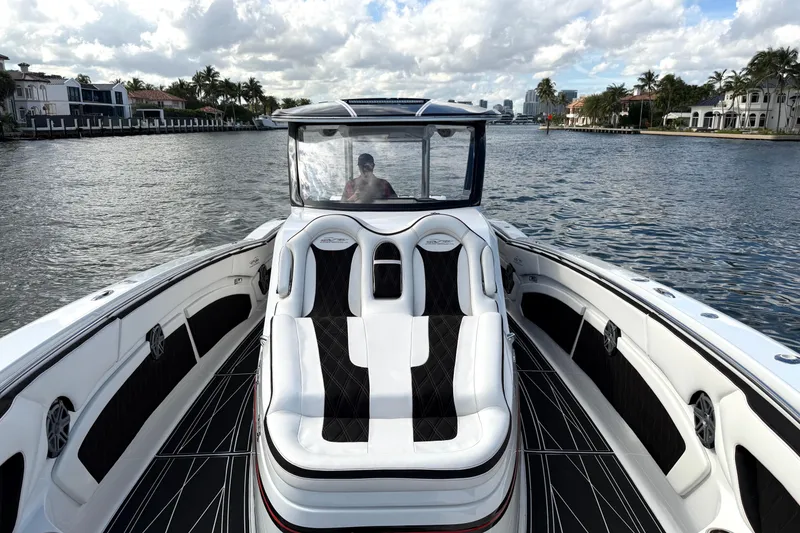 Slide: The Image of Luxury MTI V42 boat cruising on a scenic waterway, 2019 model. - 10