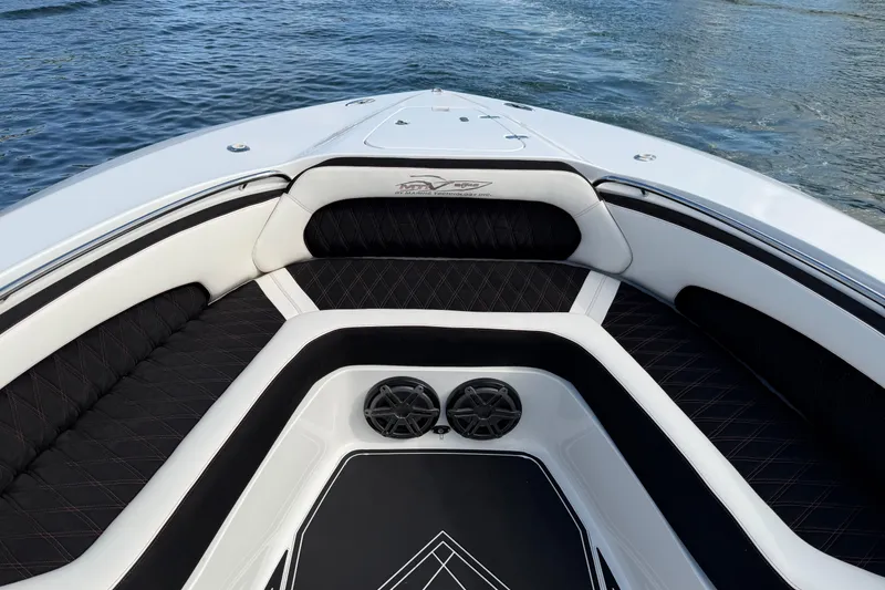 Slide: The Image of Luxury seating area on 2019 MTI V42 boat with black and white upholstery. - 11