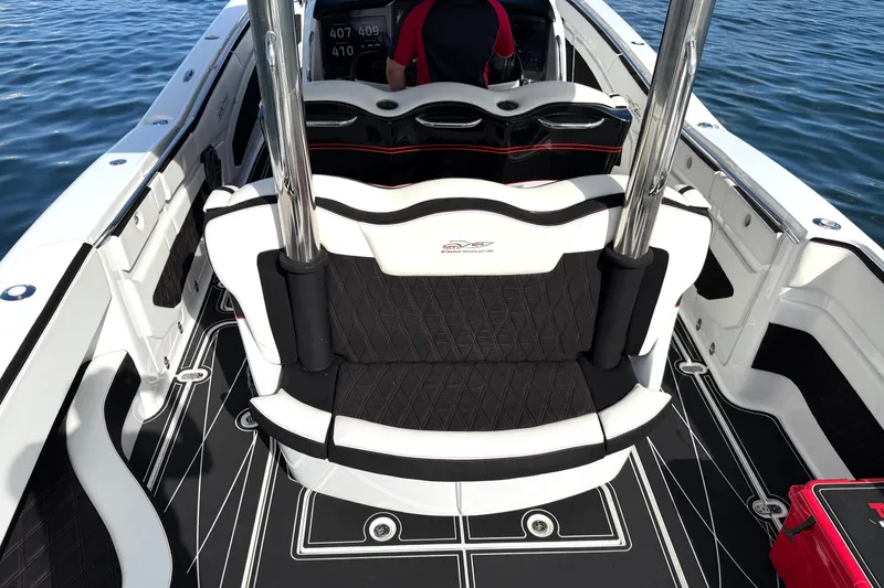 Slide: The Image of Luxury MTI V42 boat interior with black and white seating, 2019 model, on water. - 12