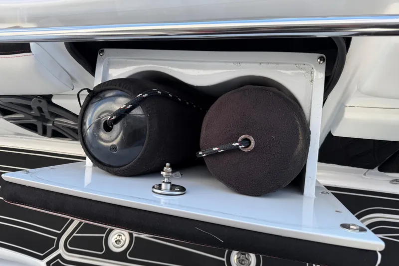 Slide: The Image of Storage compartment on a 2019 MTI V42 boat, holding two black fenders. - 19