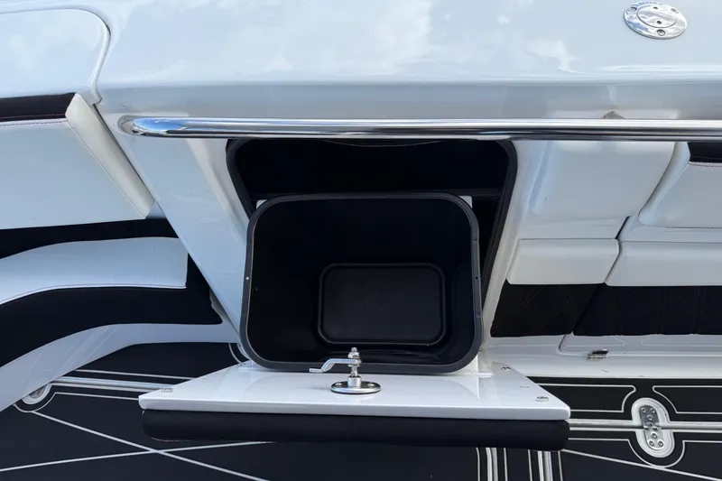 Slide: The Image of Open storage compartment on a 2019 MTI V42 boat, featuring sleek white and black design. - 20