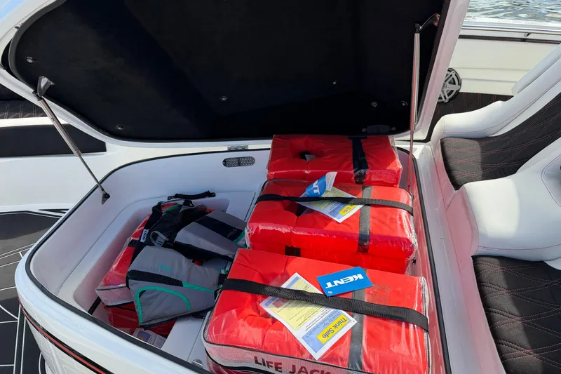 Slide: The Image of Open storage compartment on 2019 MTI V42 boat with red life jackets inside. - 25