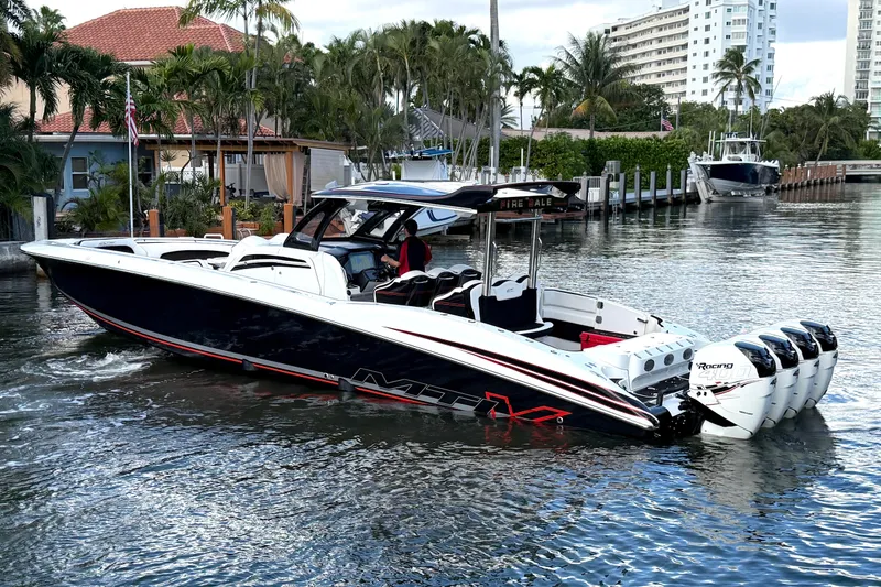 Slide: The Image of 2019 MTI V42 boat with multiple engines cruising in a scenic waterfront area. - 3