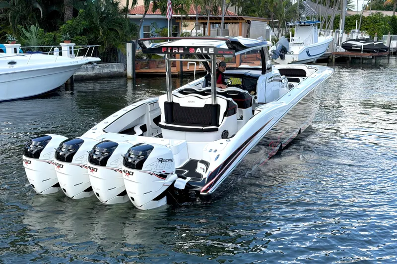 Slide: The Image of 2019 MTI V42 boat with four powerful engines on a calm waterway. - 4