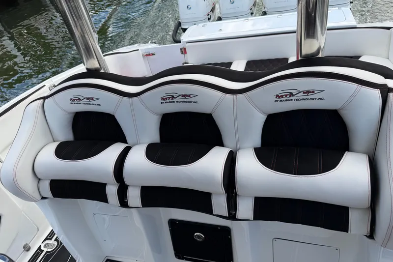 Slide: The Image of Luxury seating on a 2019 MTI V42 boat, featuring sleek black and white design. - 9