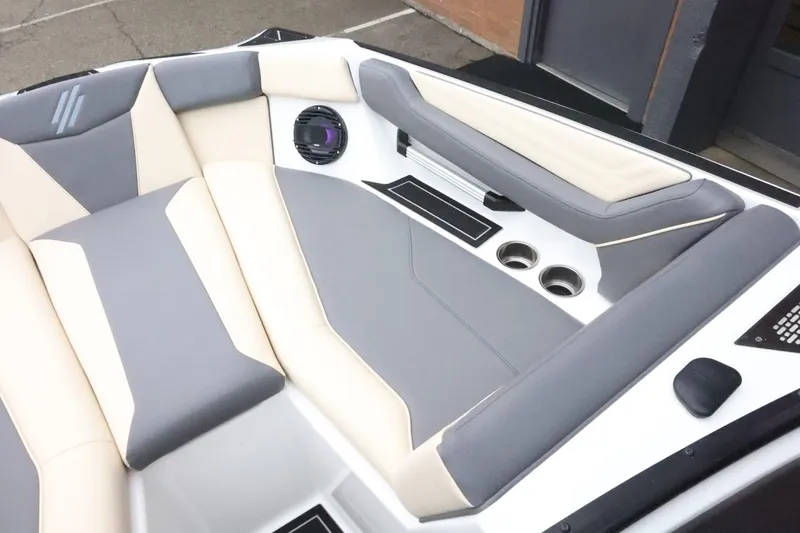 Slide: The Image of 2026 ATX Surf Boats 22 Type-S interior with gray and beige seating, cup holders, and speaker. - 17