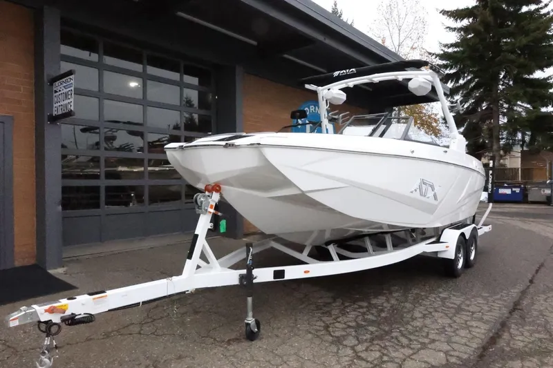 Slide: The Image of 2026 ATX Surf Boats 22 Type-S on trailer outside dealership. - 3