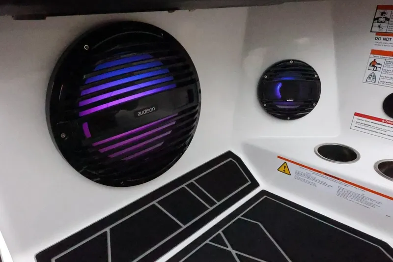 Slide: The Image of 2026 ATX Surf Boats 22 Type-S interior speakers with vibrant lighting and safety labels. - 33