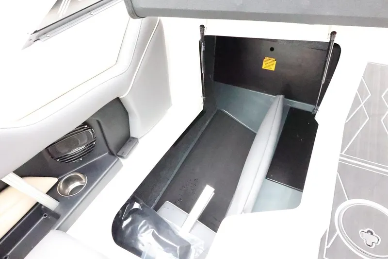 Slide: The Image of 2026 ATX Surf Boats 22 Type-S interior storage compartment with speaker and cup holder. - 34