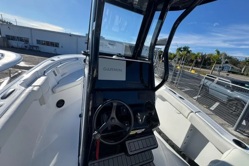 Slide: The Image of 2026 Tidewater 232 LXF boat interior with Garmin navigation system and steering wheel. - 13