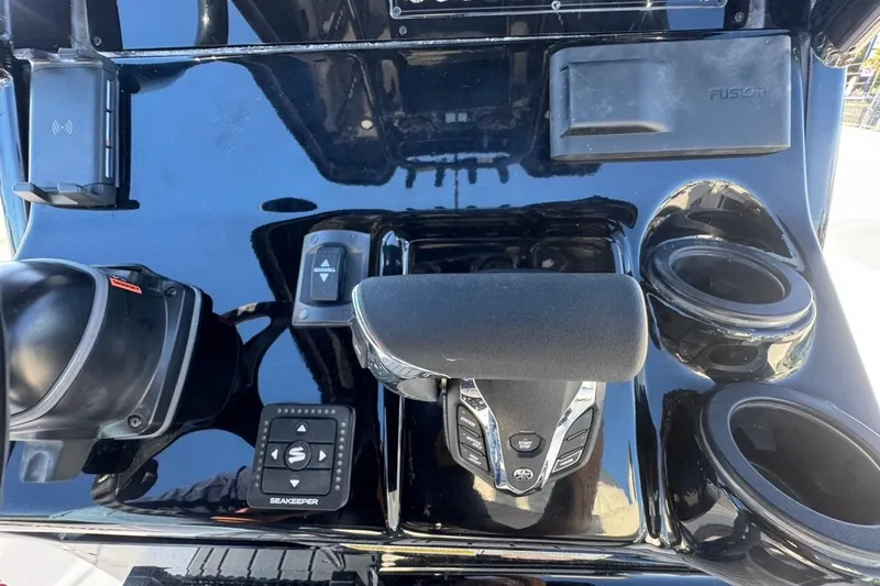 Slide: The Image of 2026 Tidewater 232 LXF boat dashboard with controls and cup holders. - 14