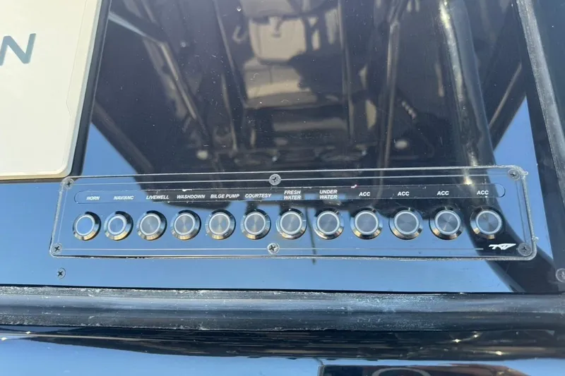Slide: The Image of Control panel of 2026 Tidewater 232 LXF boat with labeled switches. - 16