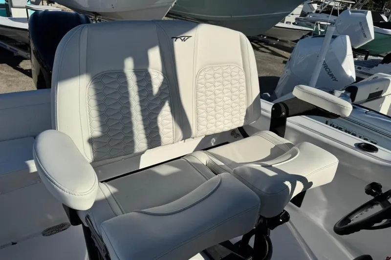Slide: The Image of 2026 Tidewater 232 LXF boat seat with white upholstery and armrests. - 17