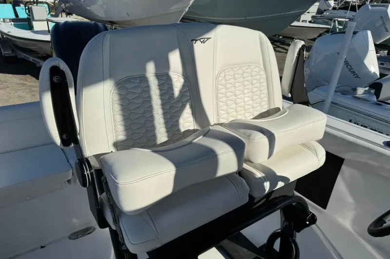 Slide: The Image of 2026 Tidewater 232 LXF boat seat with white upholstery and armrests. - 18
