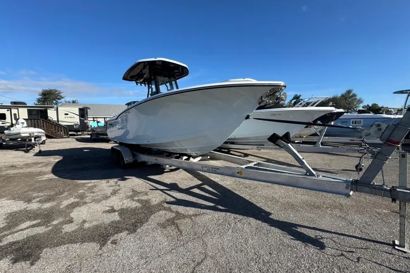 Slide: The Image of 2026 Tidewater 232 LXF boat on trailer under clear blue sky. - 2