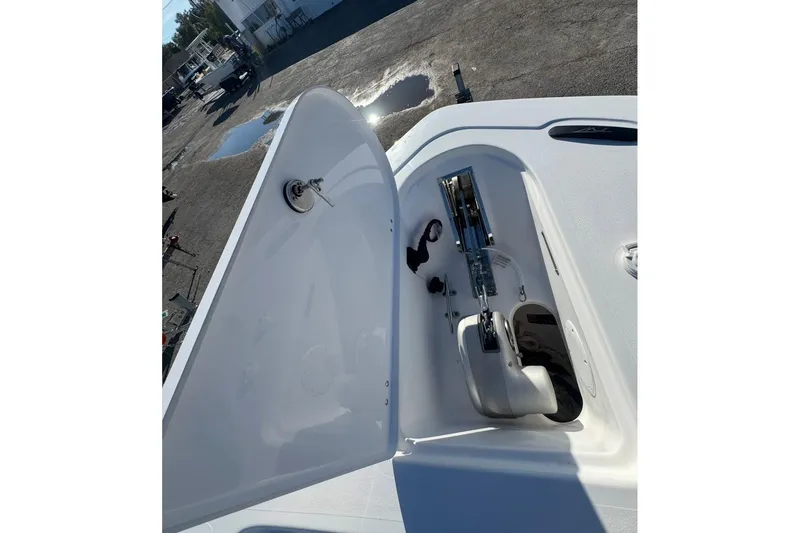 Slide: The Image of 2026 Tidewater 232 LXF boat anchor compartment open, showcasing storage and mechanism. - 26
