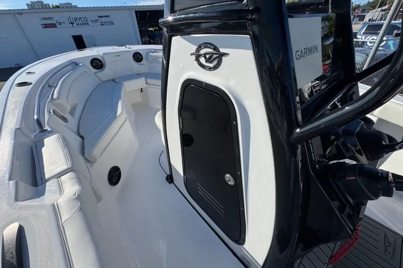 Slide: The Image of 2026 Tidewater 232 LXF boat interior with seating and Garmin equipment. - 27