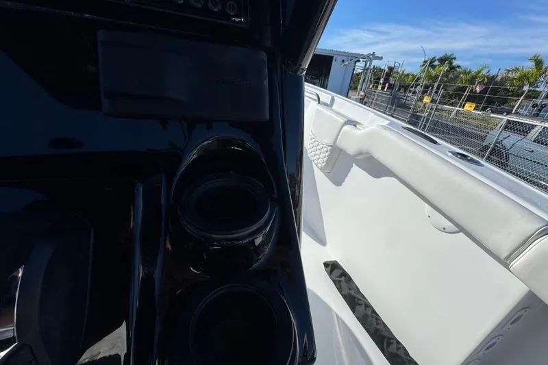 Slide: The Image of 2026 Tidewater 232 LXF boat interior with cup holders and white seating. - 29