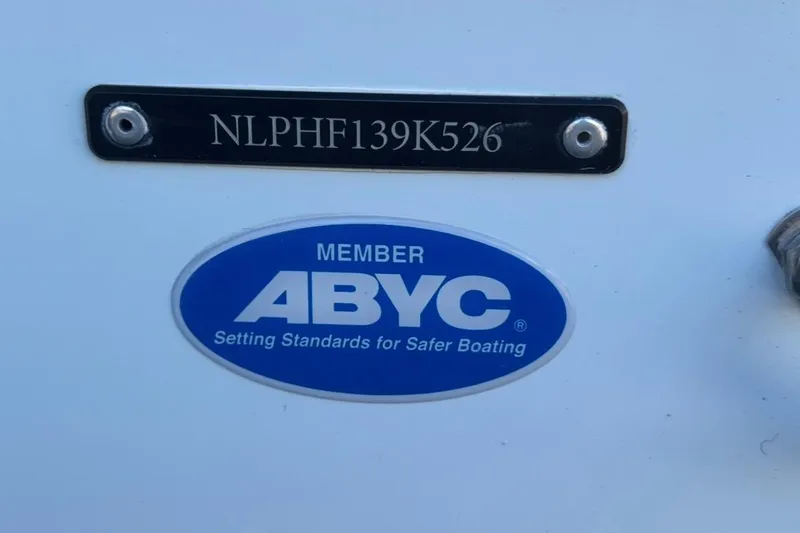 Slide: The Image of 2026 Tidewater 232 LXF boat with ABYC membership sticker and serial number plate. - 33