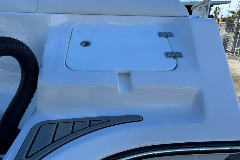 Slide: The Image of 2026 Tidewater 232 LXF boat detail, featuring a storage compartment and sleek design elements. - 7