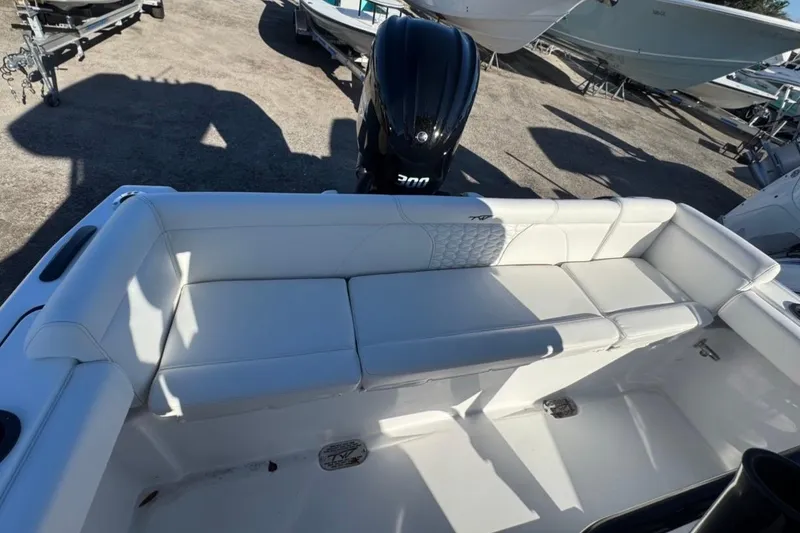 Slide: The Image of 2026 Tidewater 232 LXF boat with white cushioned seating and powerful outboard motor. - 8