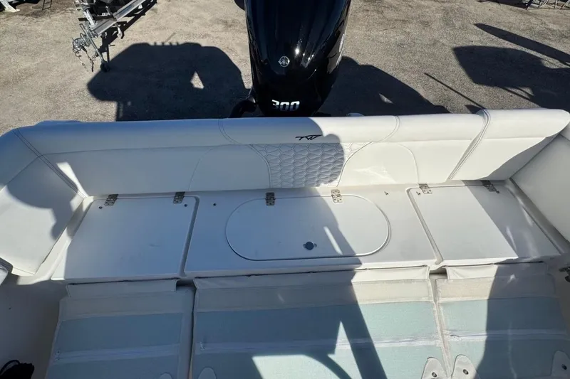 Slide: The Image of 2026 Tidewater 232 LXF boat interior with seating and engine view. - 9
