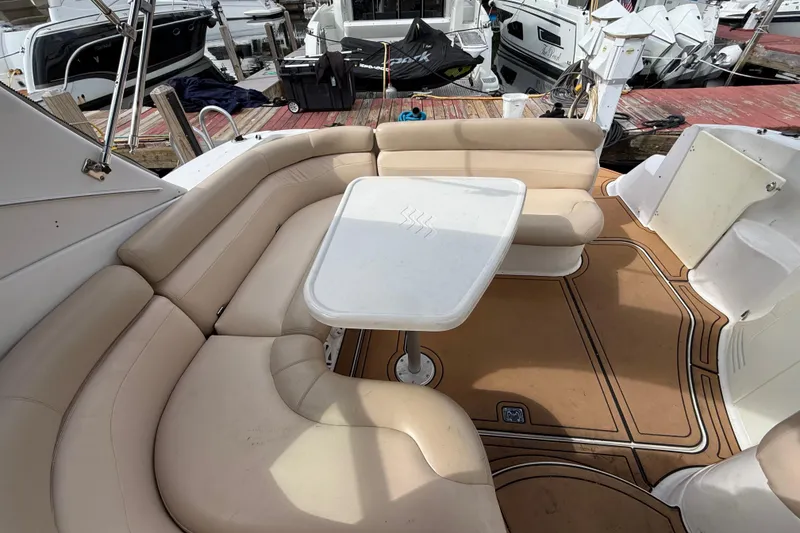 Slide: The Image of 2005 Four Winns 348 Vista boat interior with beige seating and white table. - 101
