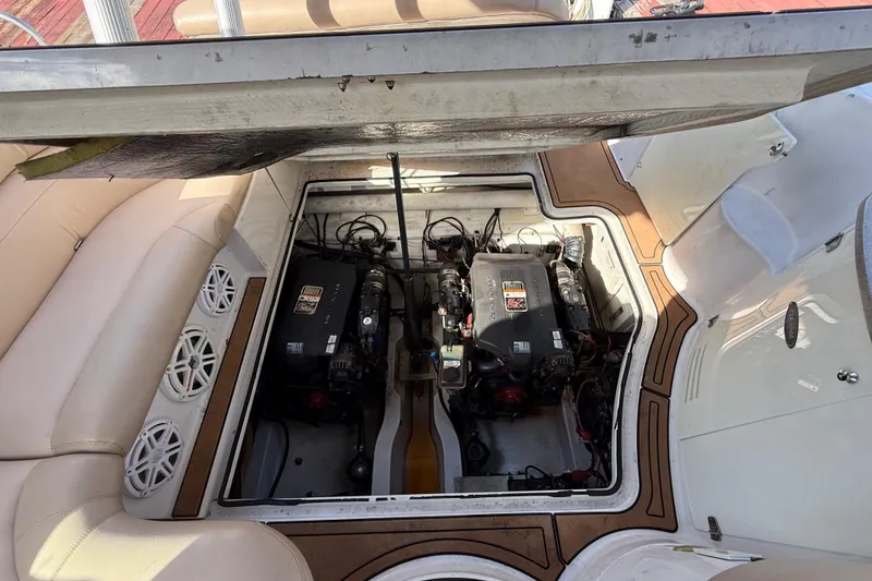 Slide: The Image of 2005 Four Winns 348 Vista engine compartment with dual engines and seating area. - 102
