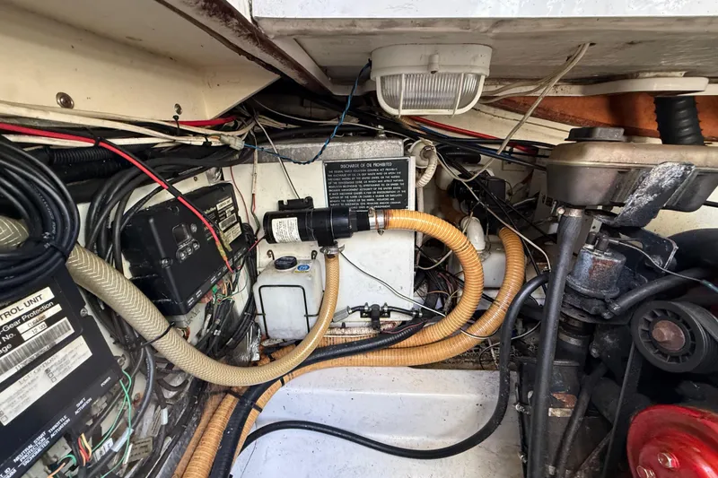 Slide: The Image of Engine compartment of 2005 Four Winns 348 Vista boat, showcasing wiring and components. - 109