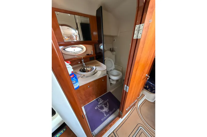 Slide: The Image of 2005 Four Winns 348 Vista boat deck with tan flooring and docked at marina. - 11