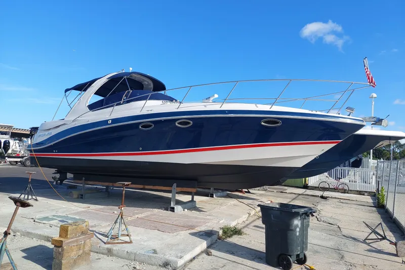Slide: The Image of 2005 Four Winns 348 Vista boat on dry dock, blue hull, sunny day. - 111